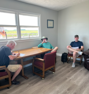 Steve, Bob, and John relax after in the Club Office/Lounge